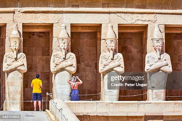 statues at the mortuary temple of queen hatshepsut - valley of the kings stock pictures, royalty-free photos & images