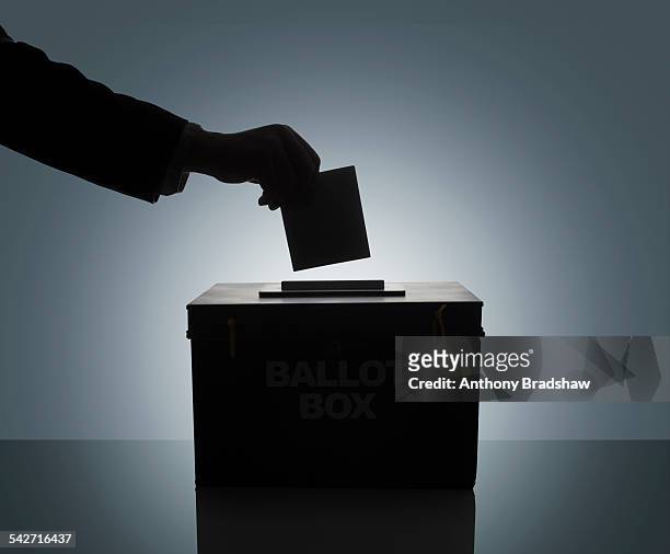 silhouette of man casting his vote - election box stock pictures, royalty-free photos & images
