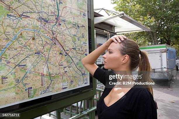 woman looking at metro map - looking at subway map bildbanksfoton och bilder