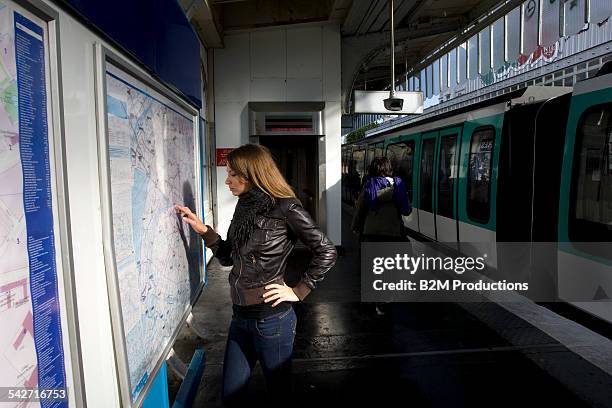 woman at metro - looking at subway map stock pictures, royalty-free photos & images