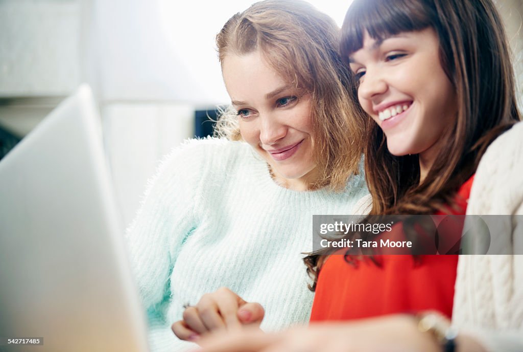 Two young women looking at laptop