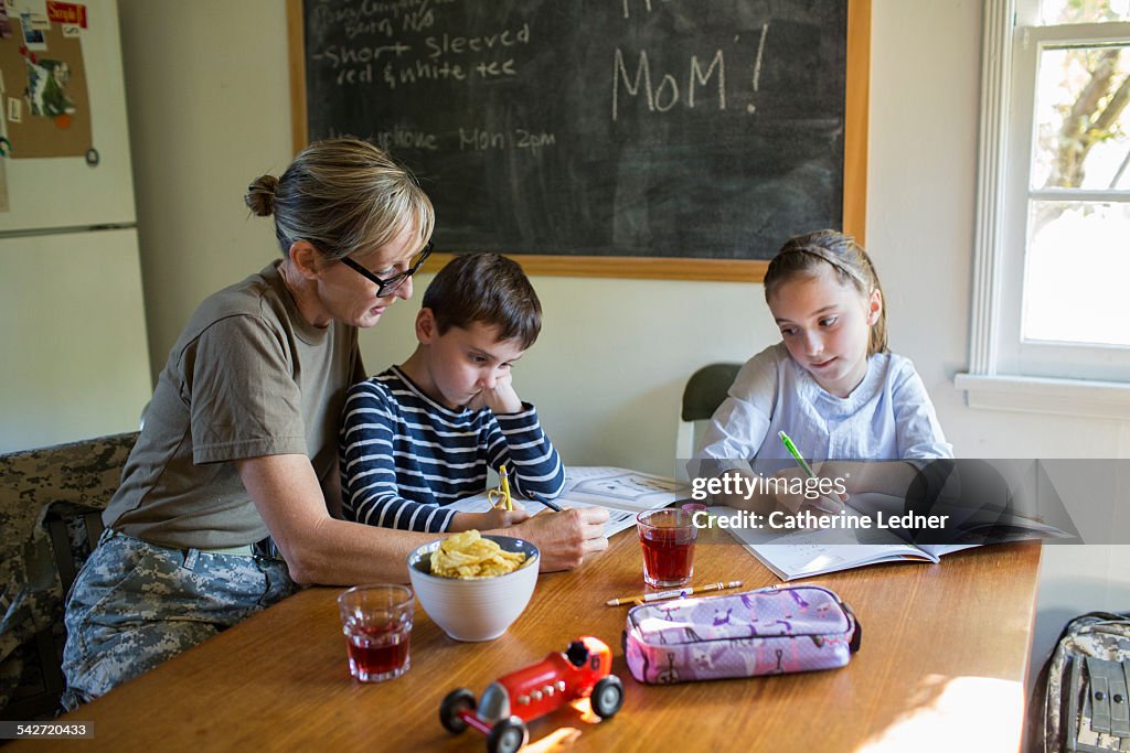 Military Mom helping her Children with Homework