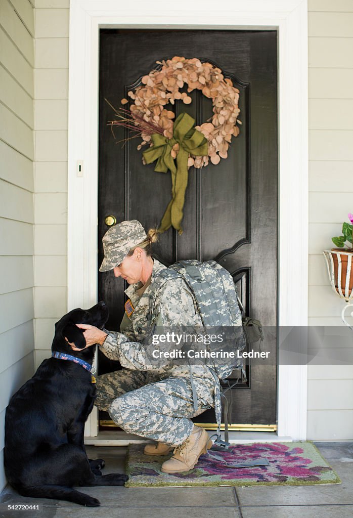 Military Woman Saying Goodby to Dog on Front Porch