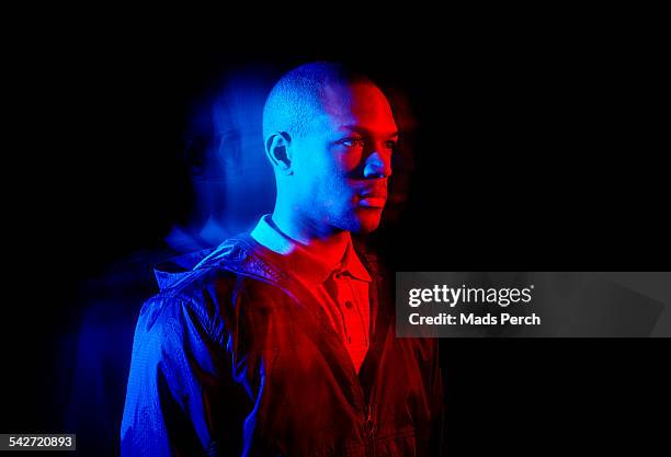 young man photographed with creative lighting - ambiente atmosférico fotografías e imágenes de stock