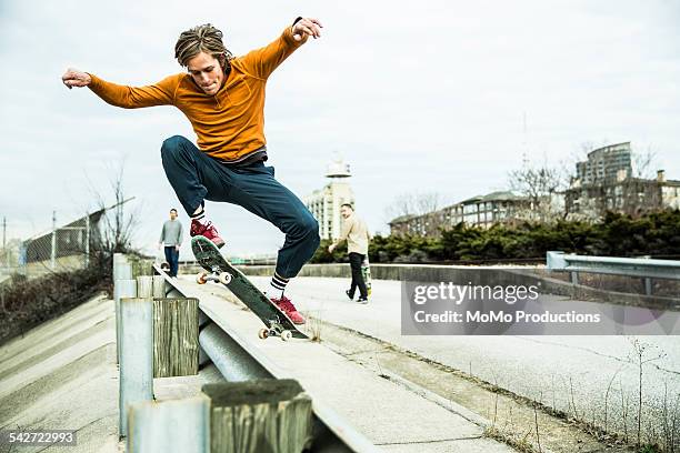 young men skateboarding in urban environment. - skater pro - fotografias e filmes do acervo