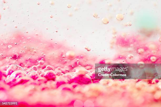 Colored liquids with bubbles, close-up