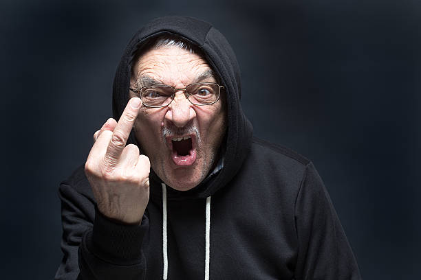 angry senior man gives finger salute - picture of someone giving the finger stock pictures, royalty-free photos & images