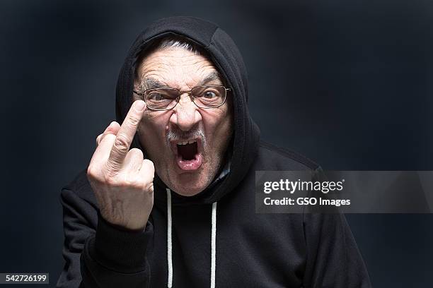 angry senior man gives finger salute - intrusion stock pictures, royalty-free photos & images