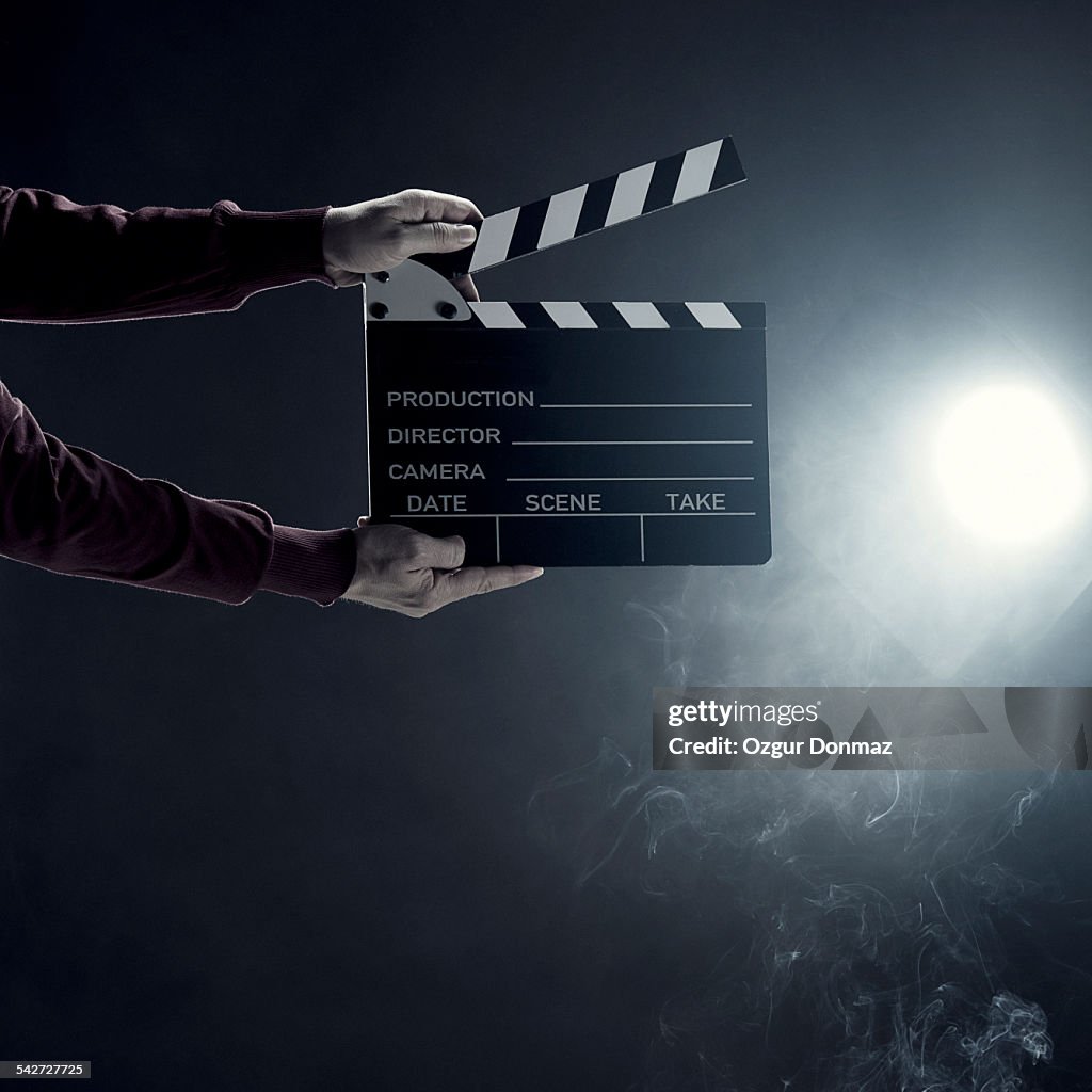 Hands holding clapperboard