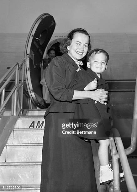 Olivia de Havilland and her 3 1/2 year-old-son Benjamin are shown as they board a plane for Cannes, France, where they will attend a film festival.