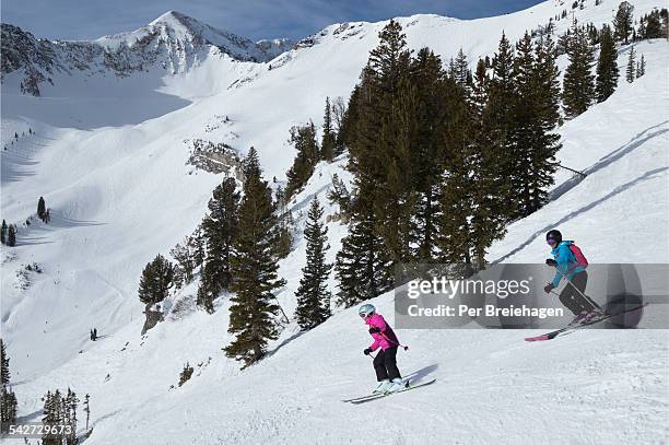 mother and daughter skiing down the mountain, utah - snowbird lodge stock pictures, royalty-free photos & images