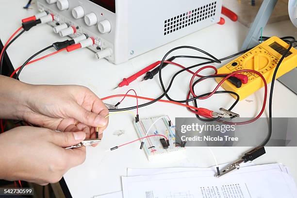 electrical engineer connecting an electric circuit - electrician stock pictures, royalty-free photos & images