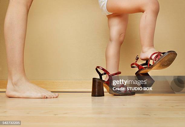 little girl with shoes of mom - child high heels stock pictures, royalty-free photos & images