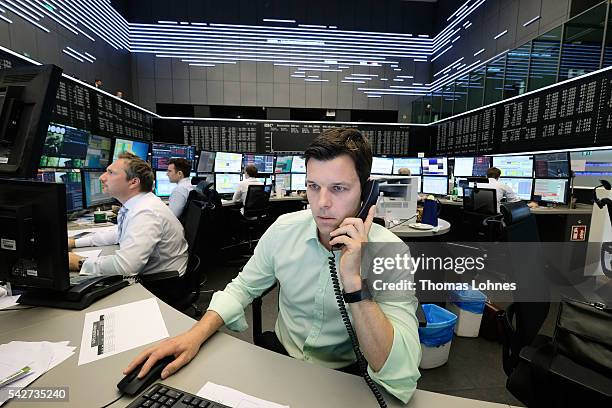 Trader sits at his desk at the Frankfurt Stock exchange the day after a majority of the British public voted for leaving the European Union on June...