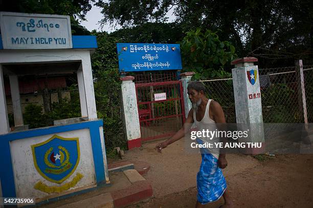 Ibrahim walks in front of the police station at Thuye Tha Mein village in Bago province on June 24 where around 70 Muslims, including children,...