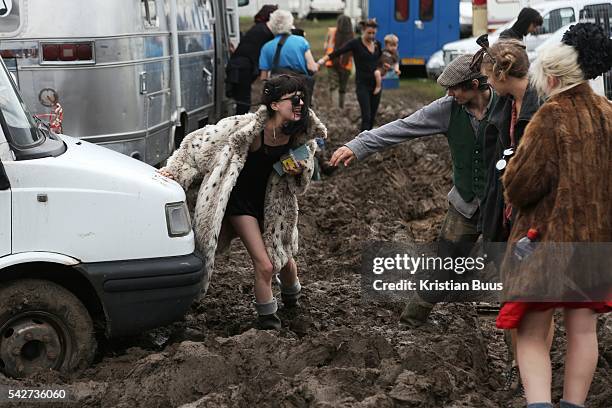 Heavy rain creates the familiar muddy base as festival goers arrive at the Glastonbury Festival in Glastonbury, United Kingdom. Glastonbury Festival...