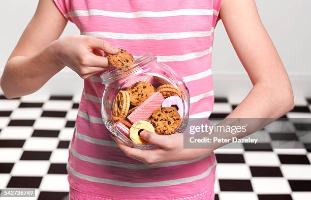 girl eating cookies - overweight stock pictures, royalty-free photos & images