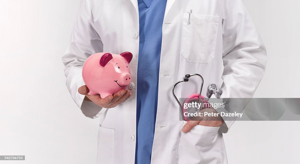 Doctor with piggy bank