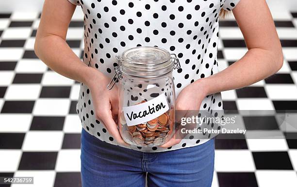 twelve year old holding holiday savings jar - 13 year old black girl stockfoto's en -beelden