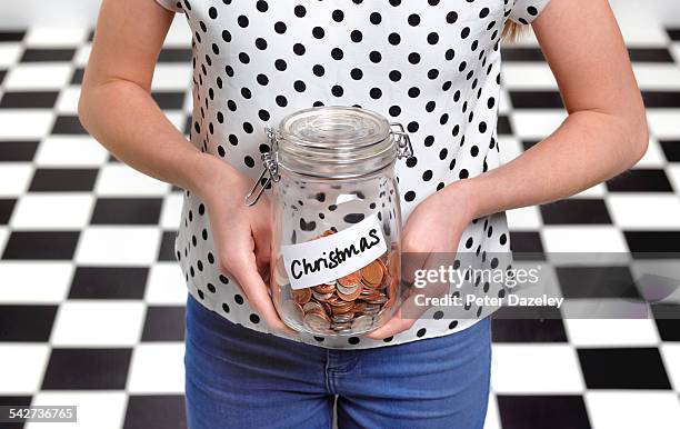 twelve year old with christmas savings jar - christmas budget stock pictures, royalty-free photos & images