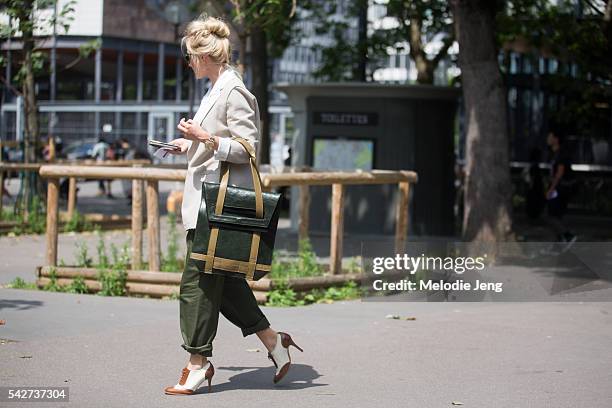 Sarah Ann Murray carries a bag by Robert Spangle The Observer collection during Paris Men's Fashion Week SS17 on June 23, 2016 in Paris, France.