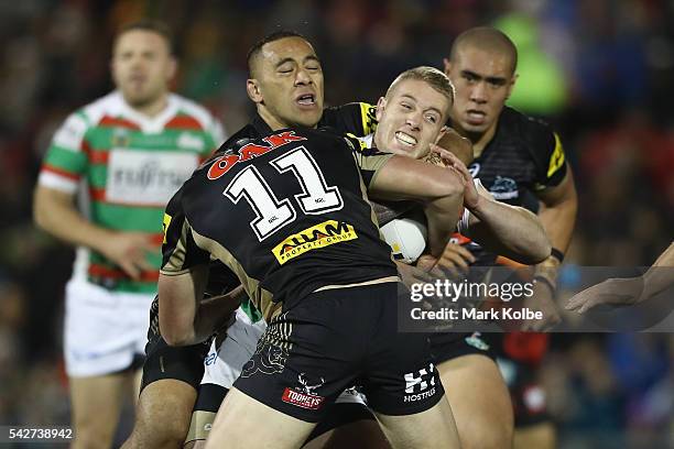 Aaron Gray of the Rabbitohs is tackled during the round 16 NRL match between the Penrith Panthers and the South Sydney Rabbitohs at Pepper Stadium on...