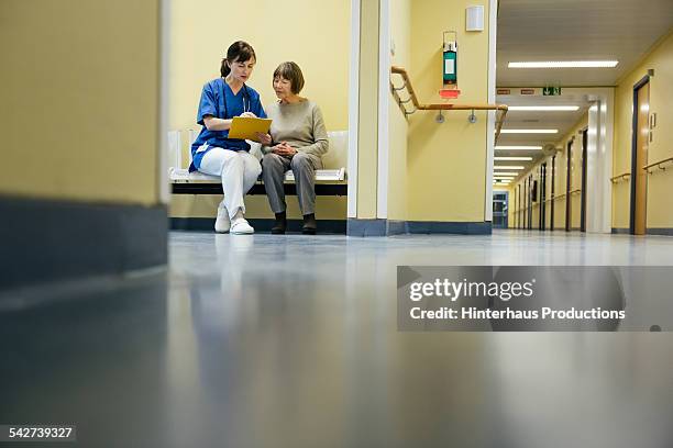 doctor and senior patient at hospital - doctor corridor stock pictures, royalty-free photos & images