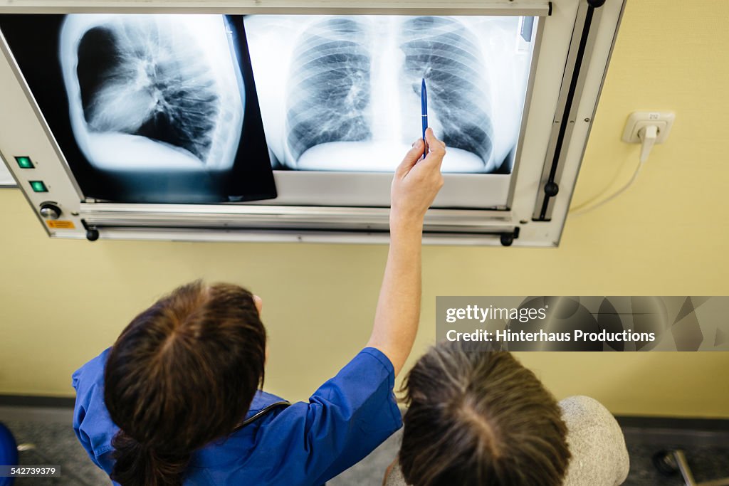 Doctor And Senior Patient Examining X-Ray