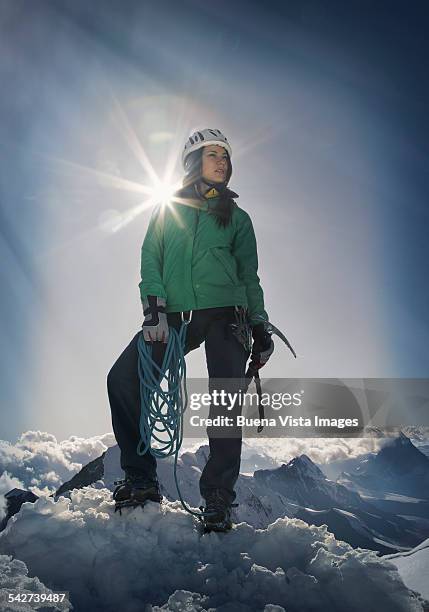 female climber on the top of a mountain - woman climbing rope stock-fotos und bilder