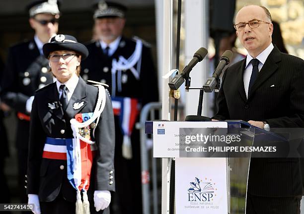 French interior minister, Bernard Cazeneuve delivers a speech next to school director Helene Martini during a ceremony of the 20th promotion of the...