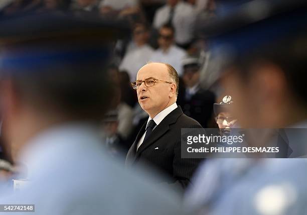 French Interior minister Bernard Cazeneuve flanked by school director Helene Martini speaks during a ceremony of the 20th promotion of the police...