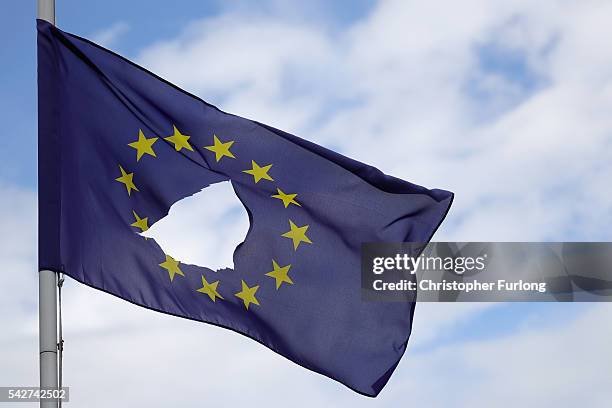 European Union flag, with a hole cut in the middle, flies at half-mast outside a home in Knutsford Cheshire after today's historic referendum on June...