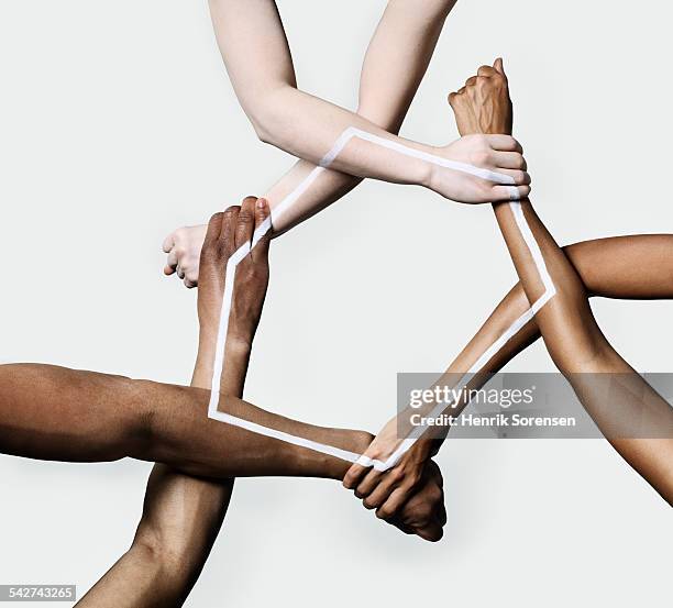 three peoples hands and arms forming a triangle - woman arm around stock pictures, royalty-free photos & images