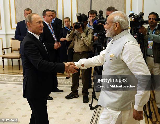 Russian President Vladimir Putin greets Indian President Narendra Modi during the Shanghai Cooperation Organisation Summit on June 24, 2016 in...