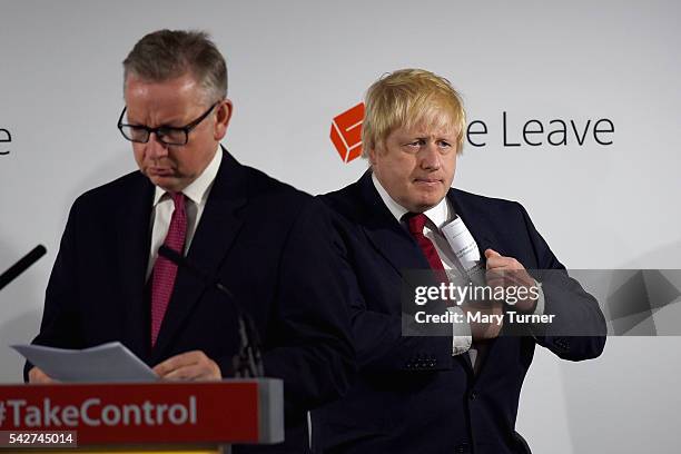 Justice Secretary Michael Gove prepares to speak following the results of the EU referendum as Conservative MP Boris Johnson listens at Westminster...