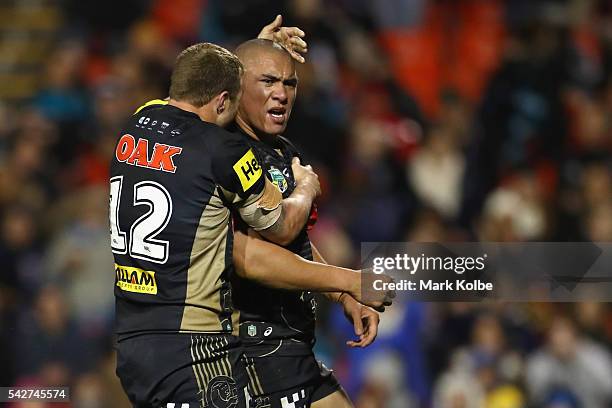 Trent Merrin of the Panthers celebrates with Leilani Latu of the Panthers as he celebrates scoring a try during the round 16 NRL match between the...