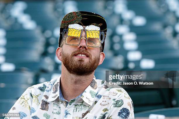 Fan wearing beer goggles sits in the stands before the game between the Oakland Athletics and the Milwaukee Brewers at the Oakland Coliseum on June...