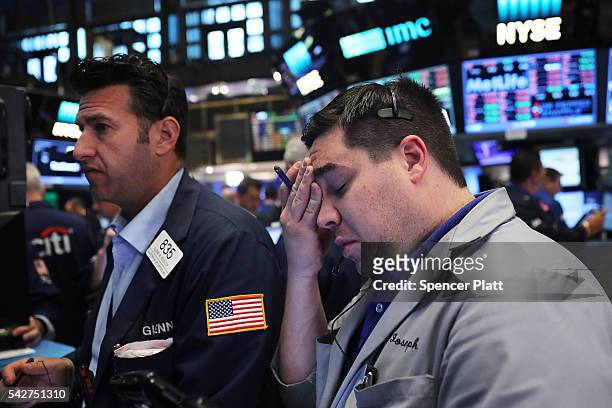 Traders work on the floor of the New York Stock Exchange following news that the United Kingdom has voted to leave the European Union on June 24,...