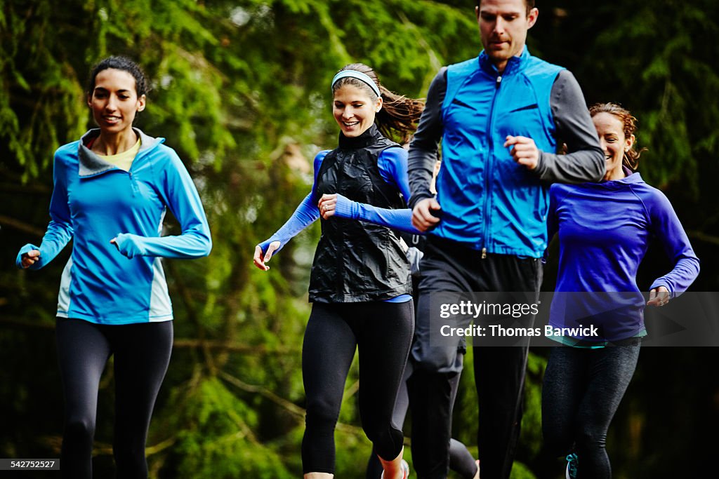 Smiling group of friends running together