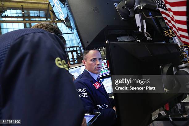 Traders work on the floor of the New York Stock Exchange following news that the United Kingdom has voted to leave the European Union on June 24,...