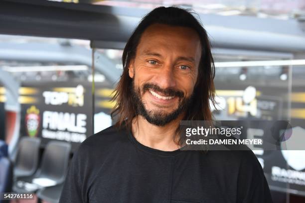 French Disc Jockey Christophe Le Friant aka Bob Sinclar smiles as he poses before the French Top14 rugby union final match Toulon vs Racing 92 at the...