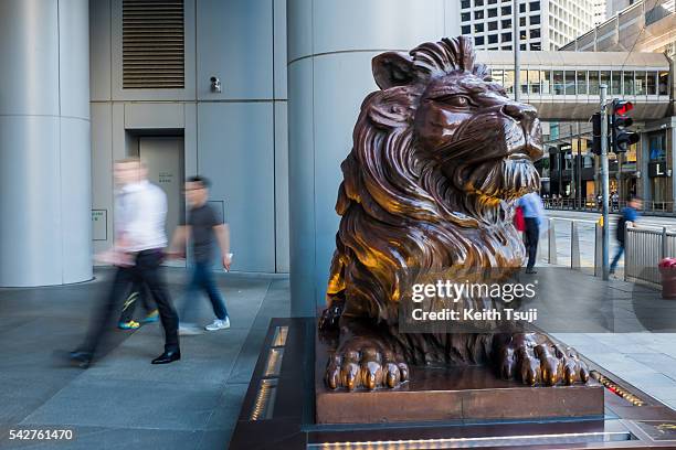 People walk in front of the HSBC Holdings plc headquarters building on June 24, 2016 in Central, Hong Kong. The result from the historic EU...