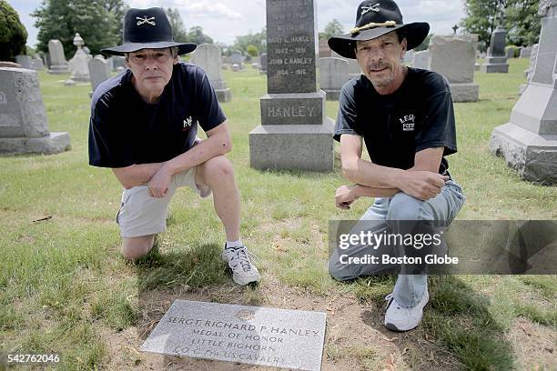 John Graham, right, and Michael Gill of American Legion Post 69 in Malden, Mass., pose next to the new foot stone at the grave site of Sgt. Richard...