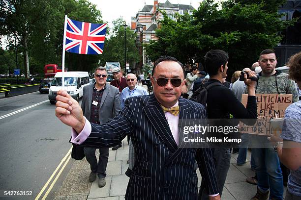 Pin striped suit protester waves his Union Jack flag at College Green in Westminster outside the Houses of Parliamant following a Leave vote, also...