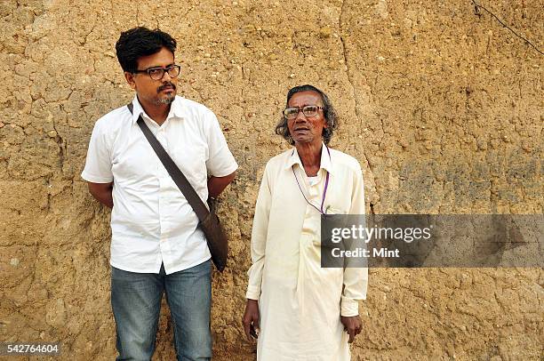 Santiniketan based artist Sanchayan Ghosh with Harakumar Gupta a local folk Leto poet and singer at China clay open-mine in Kharia village on...