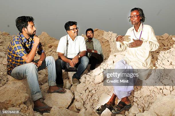 Santiniketan based artist Sanchayan Ghosh with his two students Soumyadipta and Sanjeeb and Harakumar Gupta a local folk Leto poet and singer at...