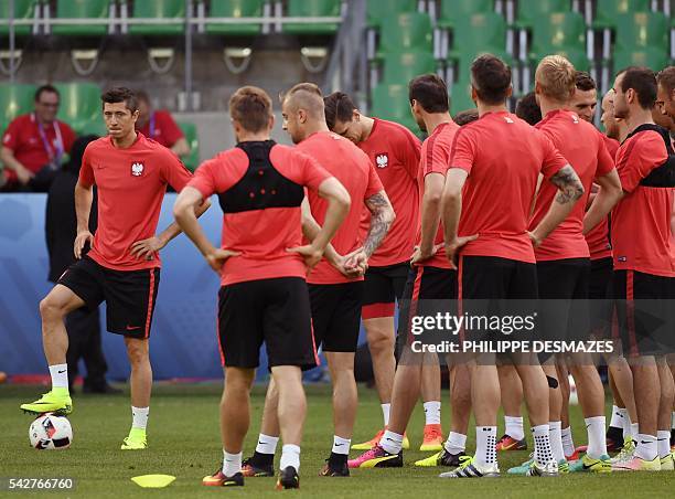 Poland's forward Robert Lewandowski and his teammates take part in a training session at the Geoffroy Guichard stadium in Saint-Etienne on June 24,...