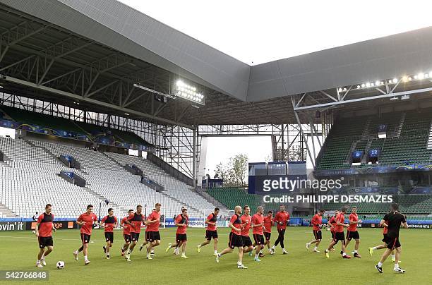 Poland's players take part in a training session at the Geoffroy Guichard stadium in Saint-Etienne on June 24, 2016 on the eve of the Euro 2016...
