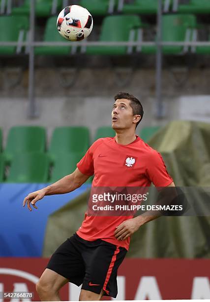 Poland's forward Robert Lewandowski takes part in a training session at the Geoffroy Guichard stadium in Saint-Etienne on June 24, 2016 on the eve of...
