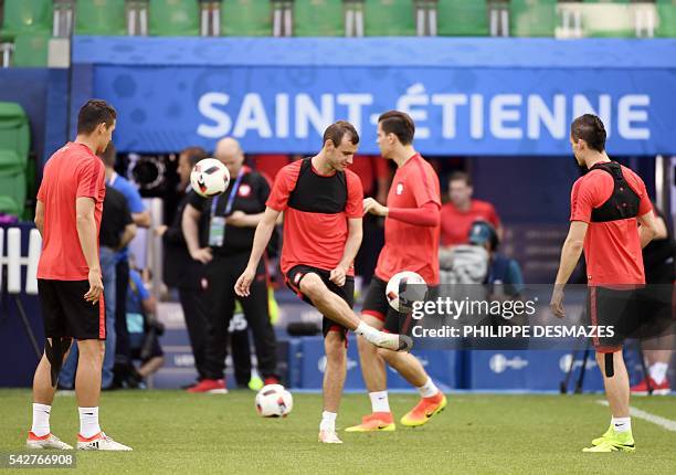 Poland's players take part in a training session at the Geoffroy Guichard stadium in Saint-Etienne on June 24, 2016 on the eve of the Euro 2016...